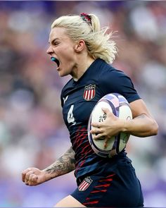 a female soccer player holding a ball and screaming