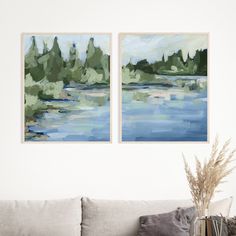 two paintings hanging on the wall above a couch