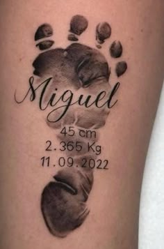 a tattoo with the name and foot print for someone's birth date on it