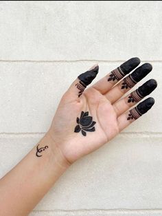 a woman's hand with tattoos on it