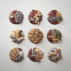 six different types of buttons on a white surface, each with an animal head and fish design