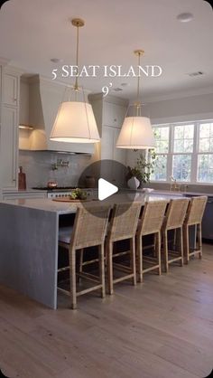 a kitchen with an island and chairs in it