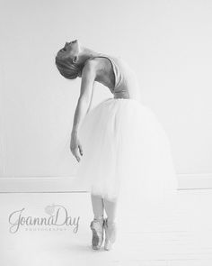 a woman in a tutu is posing for the camera