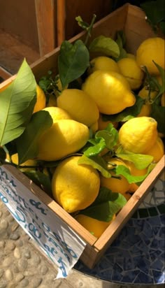 a box filled with lemons sitting on top of a table