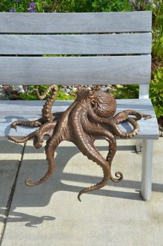 an octopus sculpture sitting on top of a wooden bench