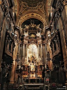 the interior of an old church with gold and black decorations on the alter, walls and ceiling