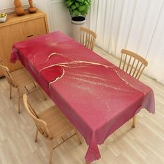 a dining room table covered with a pink cloth