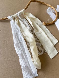 several pieces of white fabric tied together with twine on top of each other,