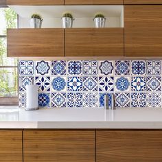 a kitchen counter with blue and white tiles on it