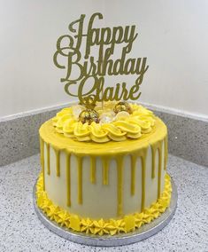 a yellow and white birthday cake with the words happy birthday charlie on it's top