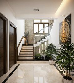 an entry way with stairs and potted plants