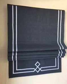 a black and white roman blind hanging on the wall