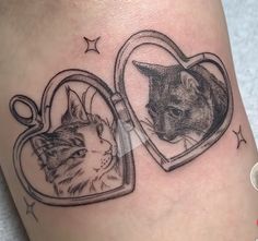 a cat and a dog in a heart shaped photo frame tattoo on the leg