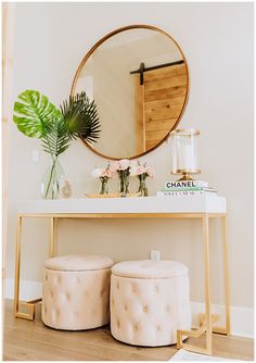 a table with two stools and a round mirror