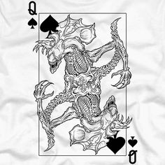 a white shirt with an image of a demon on it and playing cards in front of it