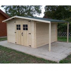 a wooden shed sitting on top of a sidewalk