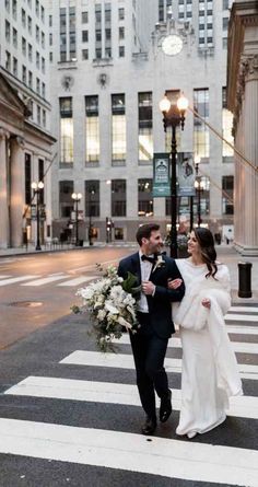 a newly married couple walking across the street