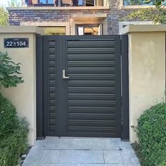 an entrance to a house with a black gate