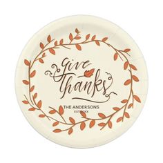 a paper plate with the words give thanks in orange and brown leaves on it, against a white background