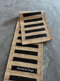 two black and white striped rugs sitting on top of each other next to each other