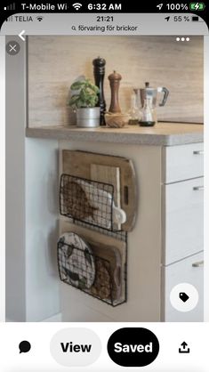 a kitchen with white cabinets and wooden counter tops, two metal baskets on the wall