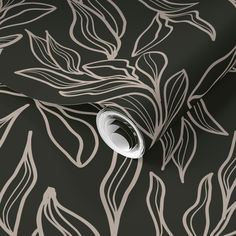 a black and white wallpaper with leaves on it