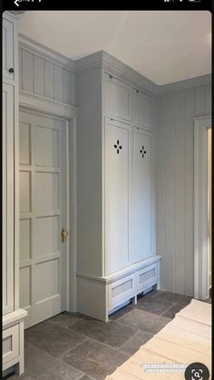 an empty room with white cabinets and gray flooring