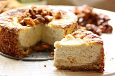 a cheesecake on a plate with one slice cut out