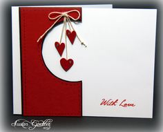 a red and white card with hearts hanging from it