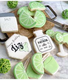 decorated cookies and limes on a cutting board