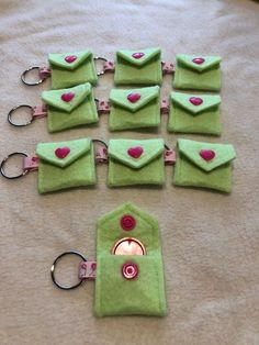 several green purses with pink hearts on them