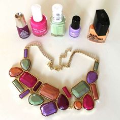 an assortment of nail polish and jewelry on a table