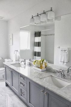 a bathroom with two sinks and a large mirror