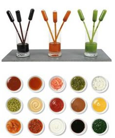 six different types of paint in small glass vases with bamboo sticks sticking out of them