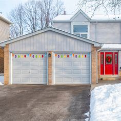 two garages with christmas decorations in front of them and snow on the ground outside