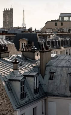 the roofs of buildings in paris are covered with metal shingles and rooftop tops, as seen from across the city