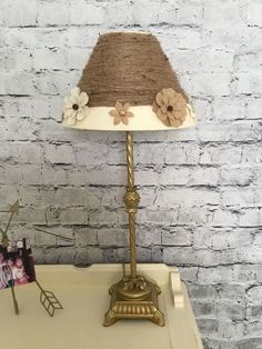 a lamp that is sitting on top of a table next to a photo and an album