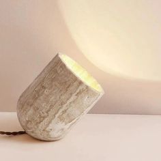 a light that is sitting on top of a table next to a lamp shade holder