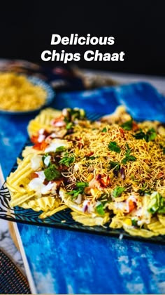 a blue plate topped with pasta covered in toppings