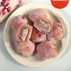 a white plate topped with cut up heart shaped marshmallows on top of a table