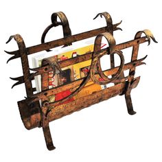 an old wooden rack with metal handles and hooks on the top, holding books in it