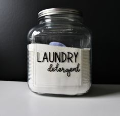 a glass jar filled with laundry detergent sitting on top of a table