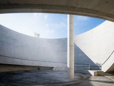 an empty concrete courtyard with stairs and benches