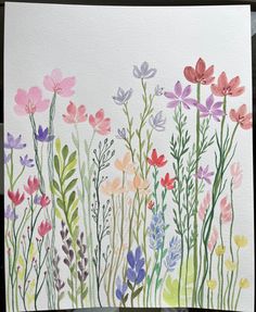 watercolor painting of colorful flowers on white paper