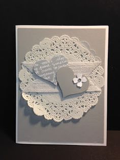 a close up of a greeting card with doily on the edge and a heart