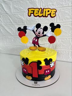 a mickey mouse cake with the number one on it