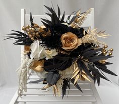 a white chair with black and gold flowers on it