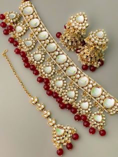 Premium quality Ruby red kundan necklace set with jhumka earring and mangtika. This beautiful Kundan choker necklace is made with  Premium quality kundan in antique gold finish.  All orders Ship same day if placed before 4:00 PM EST  Create beautiful memory for any occasion with elegant jewelry for your loved ones We will be happy to navigate you through the process so if you have any questions regarding our product before placing an order reach out to us and we will be there to help you.  Thank Red Temple Jewelry For Eid, Red Jewelry With Latkans For Eid, Red Stone Work Jewelry For Eid, Red Jewelry With Stone Work For Eid, Red Jewelry For Eid Celebration, Eid Gift Red Jewelry, Red Chandbali Jewelry For Eid, Diwali Gift Chandbali Lehenga, Red Jewelry With Mirror Work For Festive Occasion