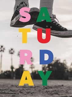 a person jumping in the air with their feet on top of letters that spell out say, saturday