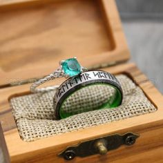 an engagement ring in a wooden box with the words made in heaven engraved on it